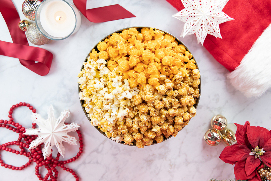 Overhead view of popcorn tin with holiday surroundings